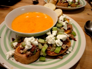 topped sweet potato rounds alongside red pepper soup
